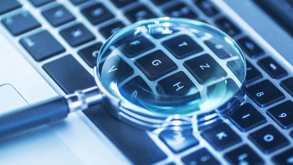magnifying glass on computer keyboard