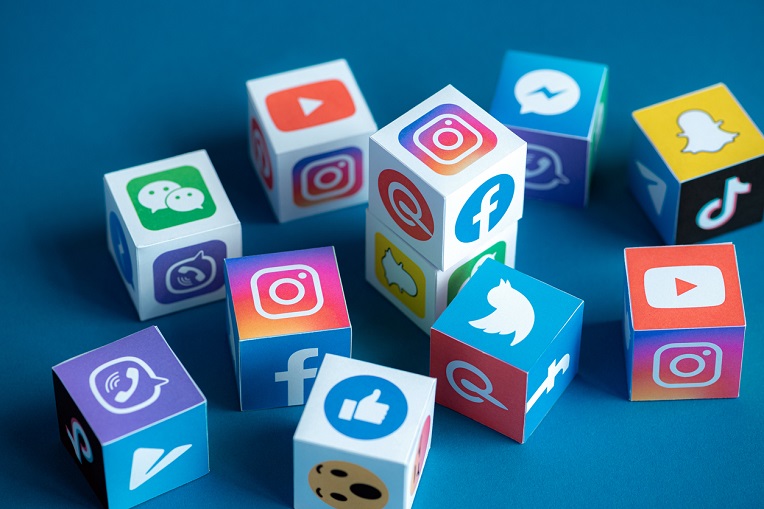 Colorful cubes featuring icons of popular social media platforms highlighting social media for business.
