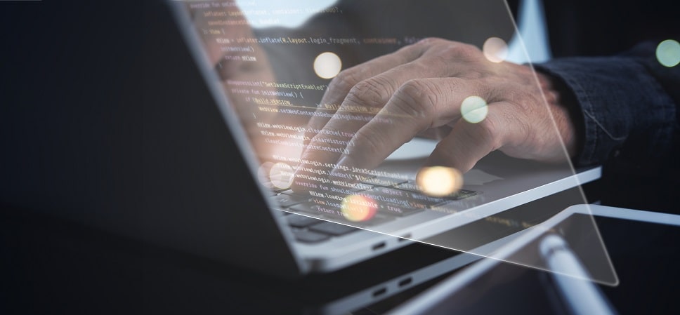 Website developer coding on a laptop