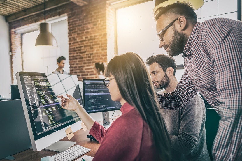 coworkers looking at the html of their computer