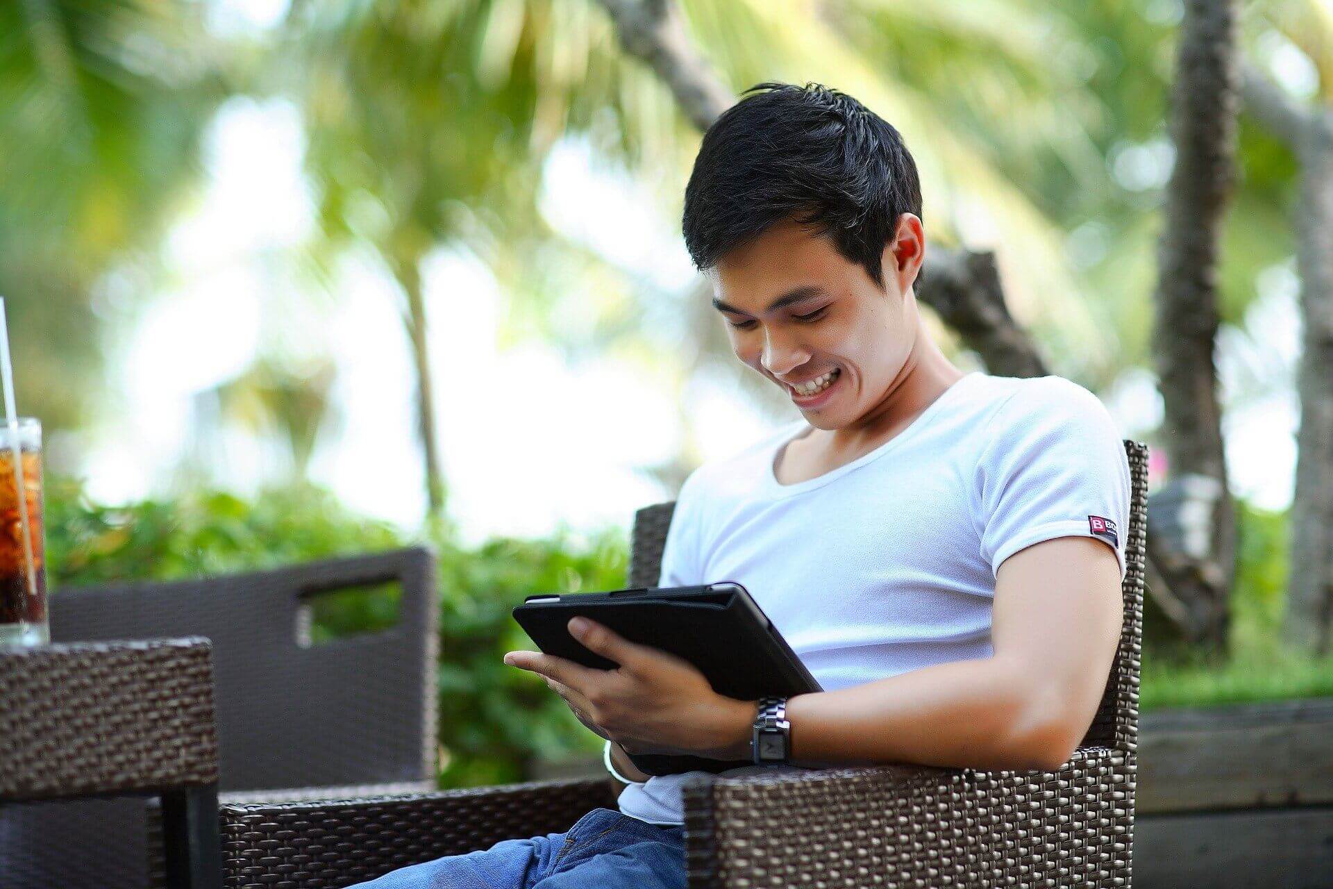 man sitting on ipad