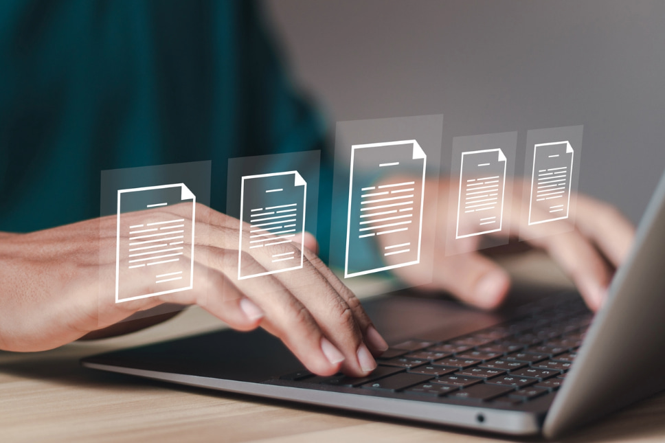 Professional working on a laptop with 5 virtual content items displayed, illustrating importance of data organization