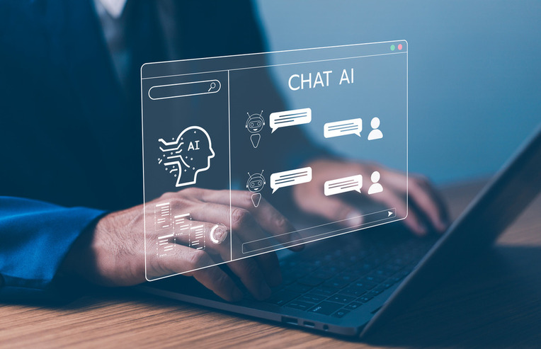 Person using AI-powered chatbot interface on laptop, illustrating artificial intelligence chat solutions and agency services