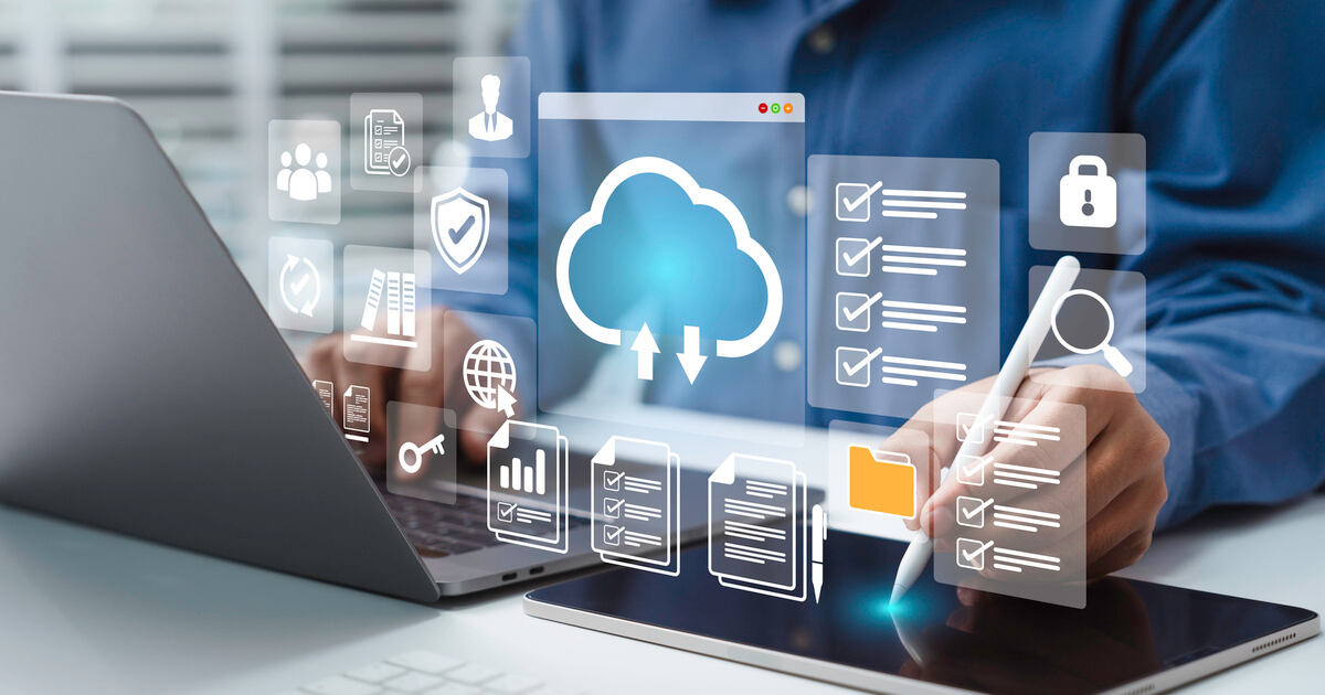 Person using laptop with cloud, security, and content management icons, representing enterprise content infrastructure.
