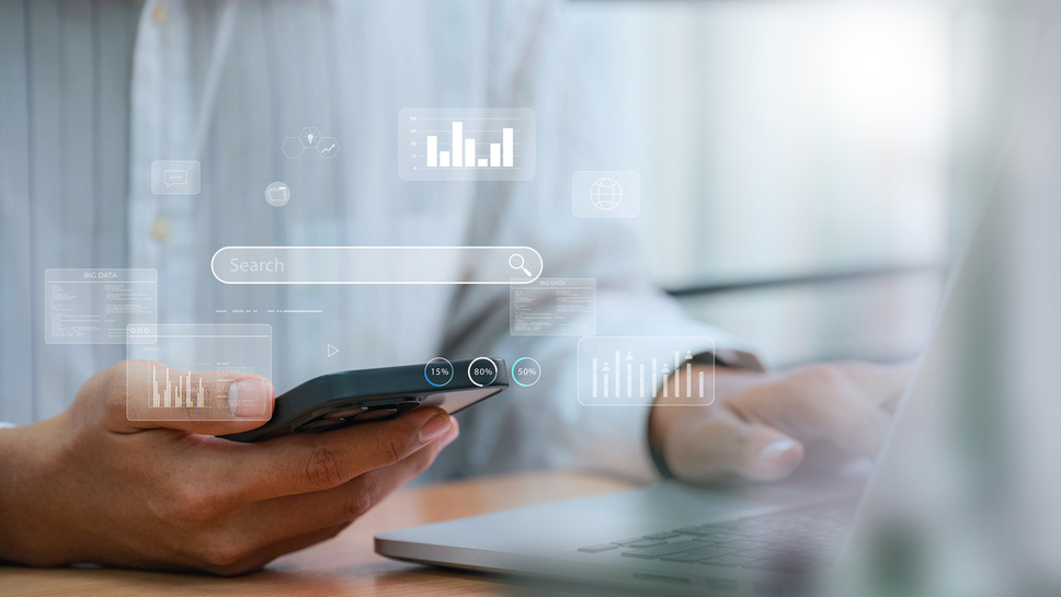 Professional using digital devices with search results data overlays, indicating success with Algolia neural search services