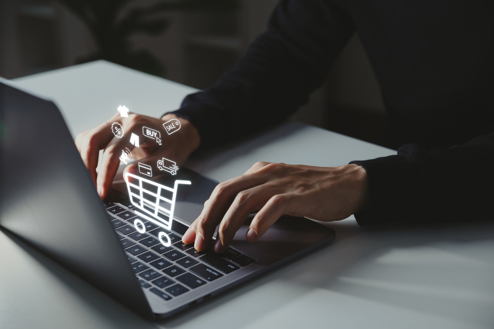 Business person using laptop to seamlessly manage ecommerce store, symbolizing success with BigCommerce agency services