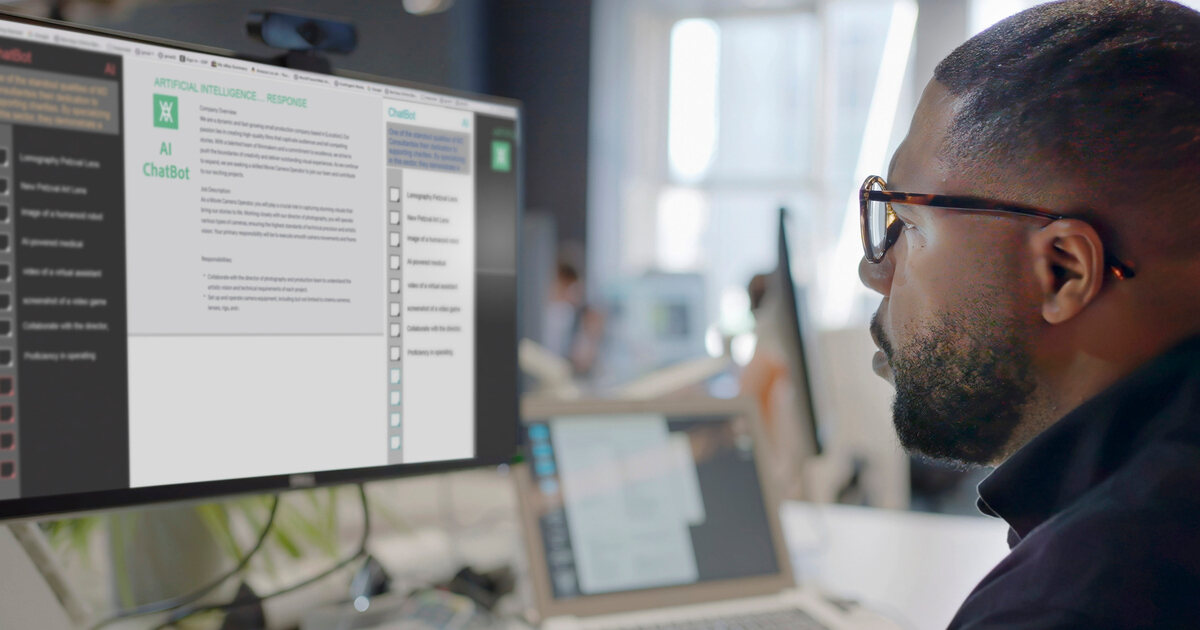 Person reviewing AI chatbot content on a desktop monitor, illustrating websites optimized for both human users and AI agents.