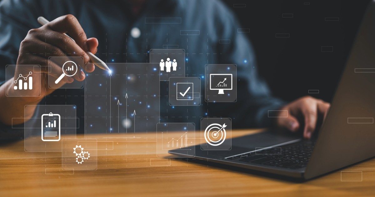 Professional working on a laptop with digital icons representing successful marketing services and content mapping strategies
