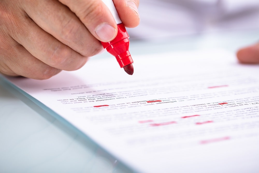 proofreading a paper with red pen