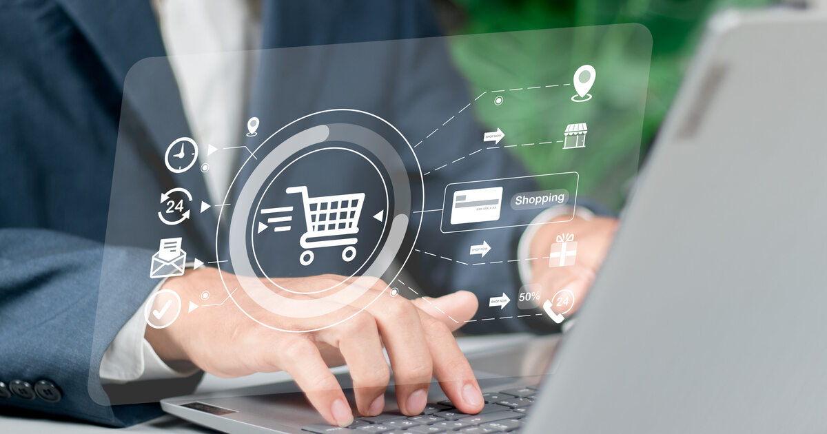 Person on laptop with digital shopping cart and ecommerce icons representing omnichannel commerce and digital retail strategy