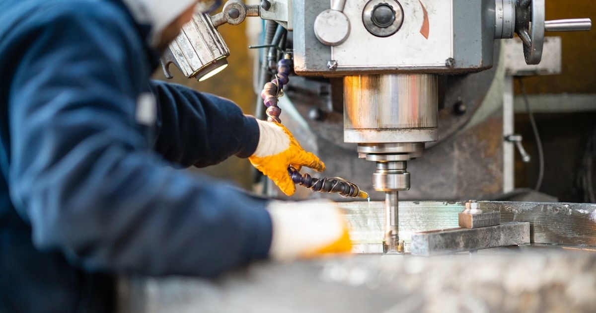 Worker operating industrial machinery, showcasing business growth with digital marketing for manufacturing companies