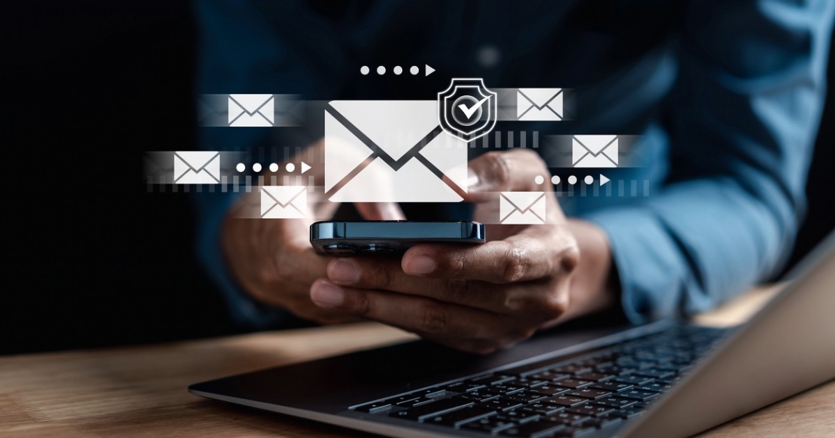 Person using digital devices, implementing accessible and inclusive email design best practices for modern marketing success