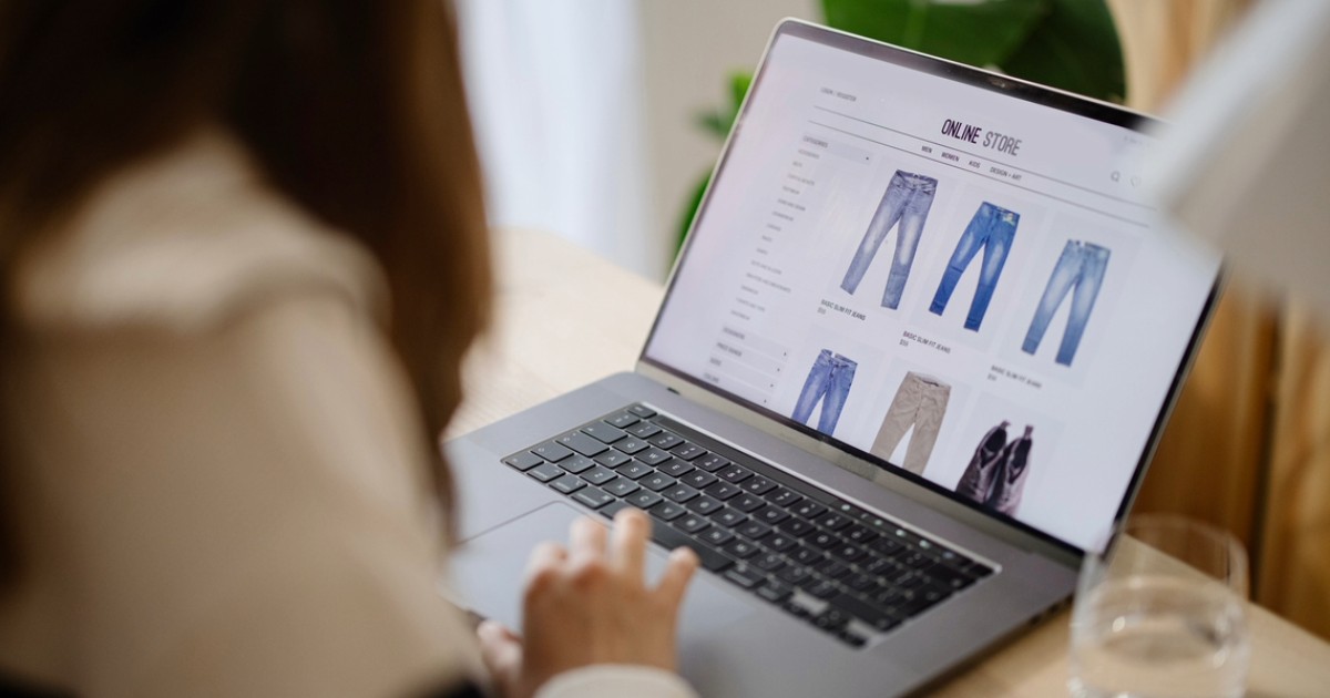 Person using laptop to browse products on an online store, representing successful headless Bigcommerce storefront experience