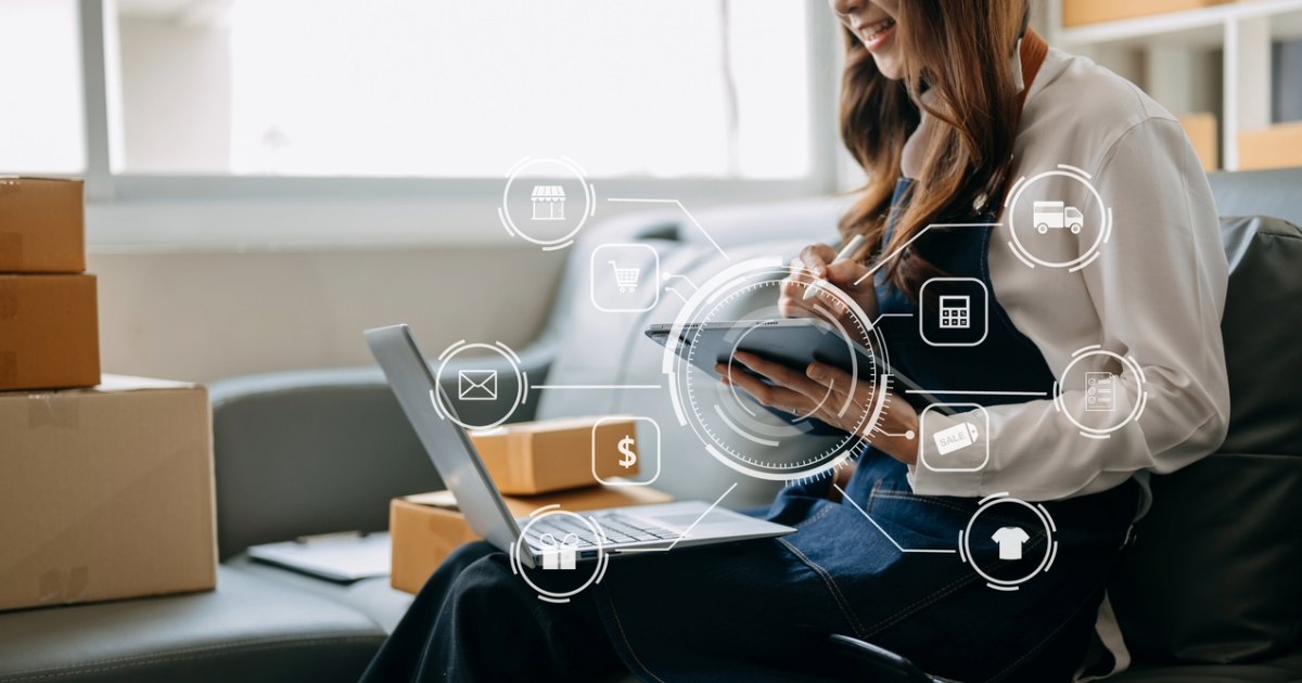 Person managing online orders using devices, indicating success with B2B portals that streamline digital customer experiences