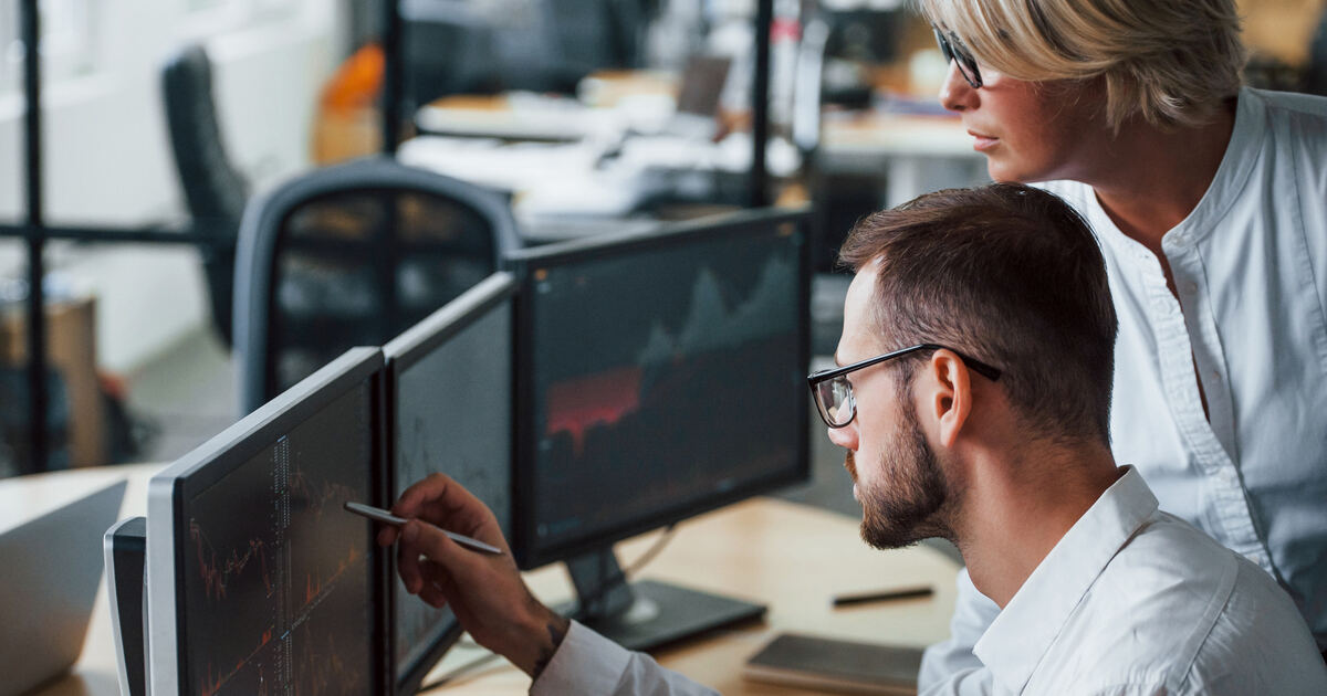 Marketers reviewing financial charts, representing marketing automation, analytics, and risk management in financial services