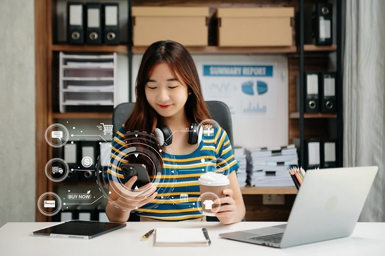 Woman with headphones using smartphone with interactive shopping and payment icons, depicting omnichannel marketing strategies.