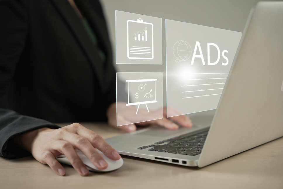 Professional on laptop displaying Google Ads account dashboard, representing business success with digital marketing agency