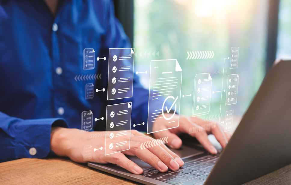 Business professional using laptop to manage digital content, indicating success with interactive content management services
