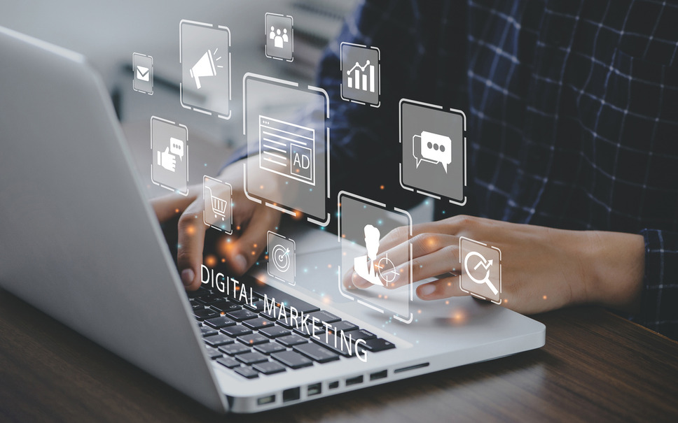 Person using laptop to improve search ad quality scores, indicating business success with digital marketing agency services