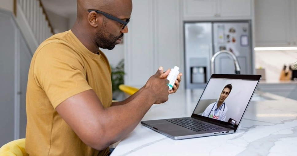Patient having virtual consultation with a doctor using laptop, showcasing success with Sitecore healthcare website services