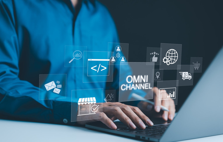 Professional using laptop with digital interface displaying successful omnichannel marketing strategies for ecommerce