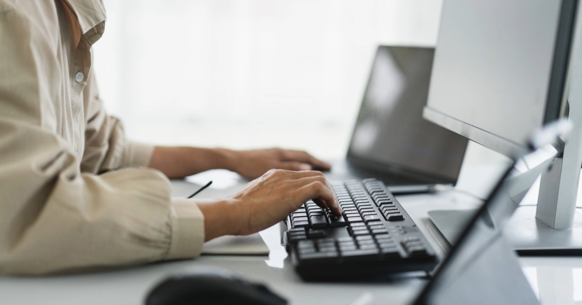 Person exploring Kentico websites developed by Americaneagle.com, showcasing web development services for various industries
