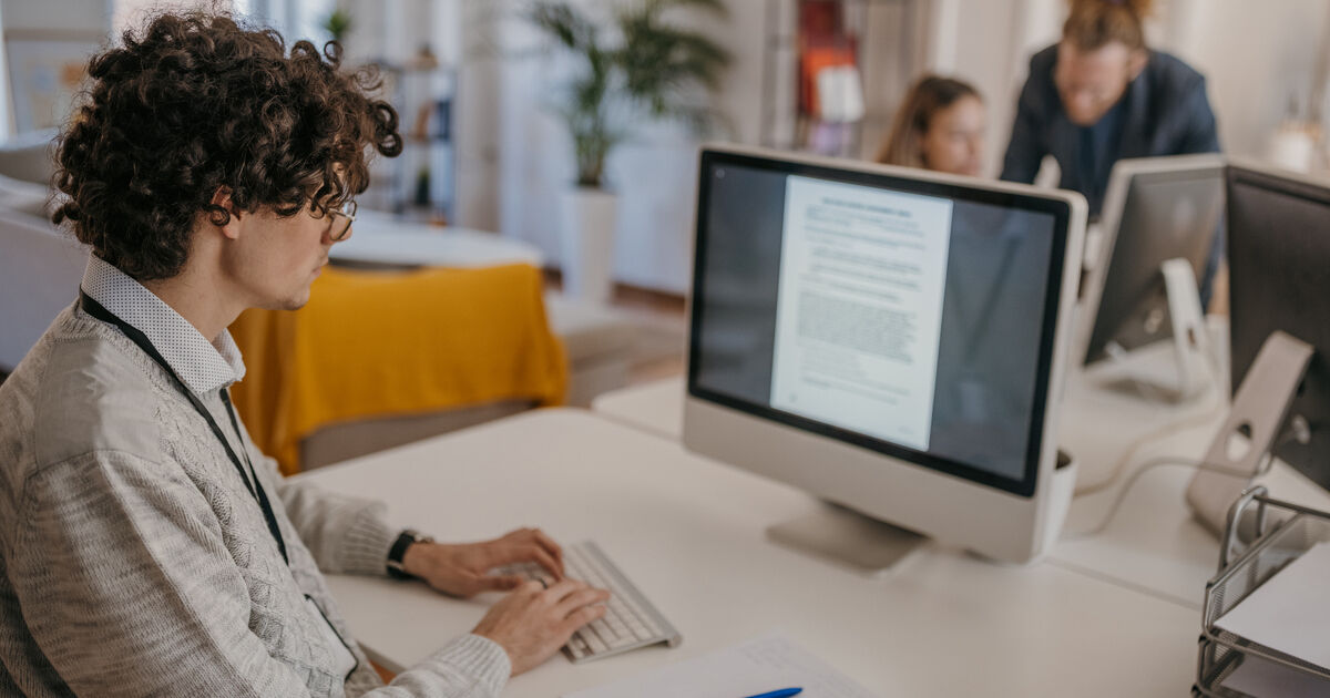 Keyword Stuffing in SEO Marketer in an office reviewing website content for SEO optimization, keyword density, and search engine best practices.