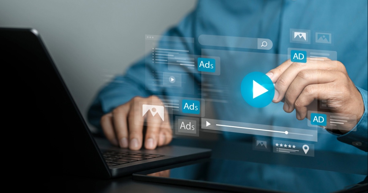 Person using video advertising interface and PPC campaign ad formats for YouTube and Google Ads marketing strategy on laptop