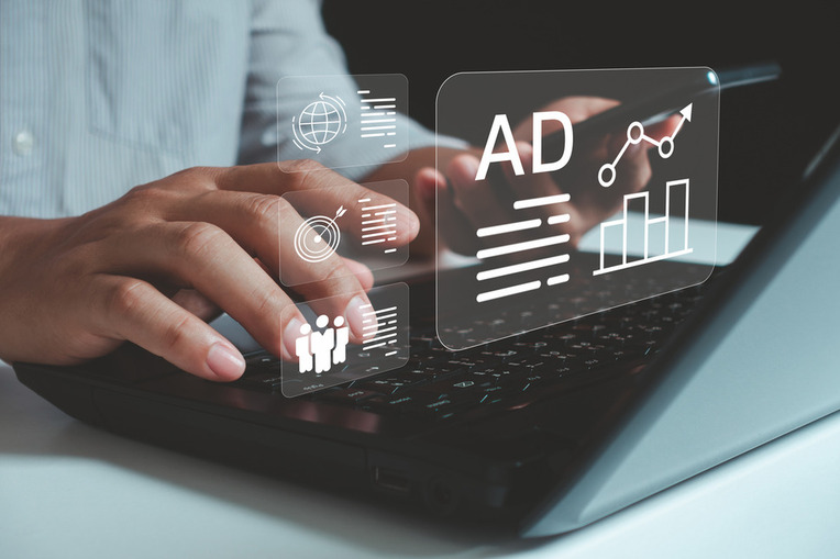 Professional analyzing Microsoft PPC Ads data on laptop, signifying business success with digital marketing agency services