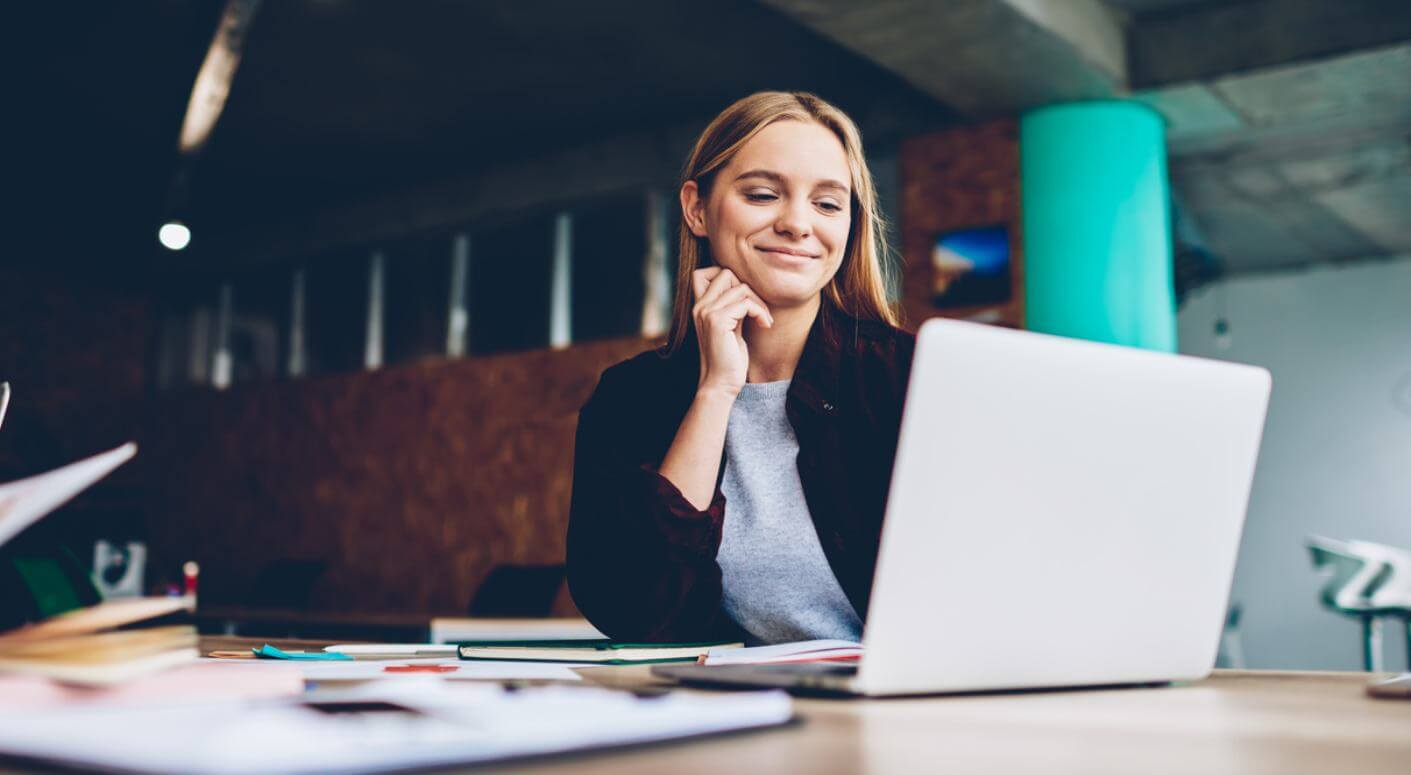 lady working on her computer smiling