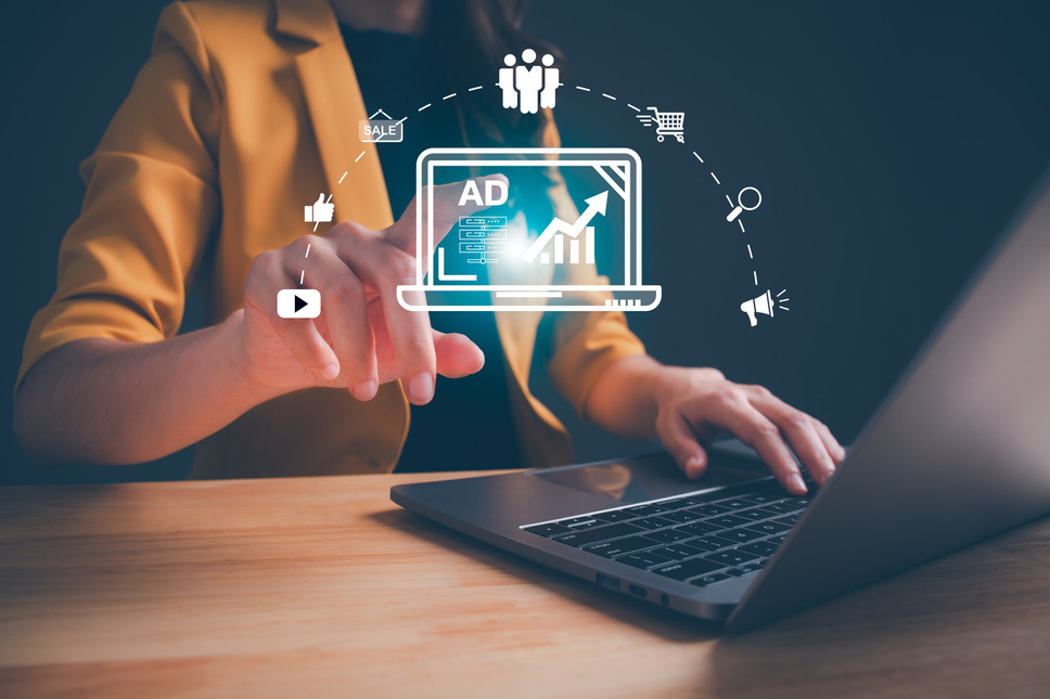 Person using laptop to manage digital advertising campaigns for ecommerce, representing online growth and customer engagement