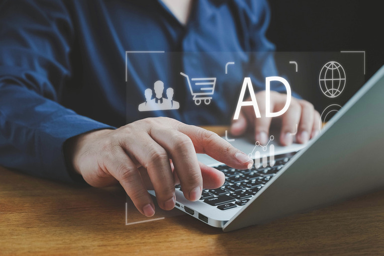 Person using a laptop to manage PPC ads and analytics, depicting success with digital marketing agency services for ecommerce