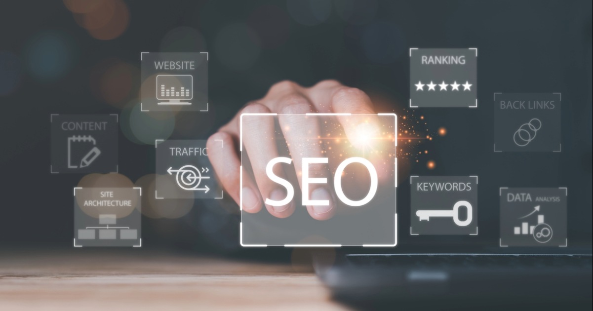 Person leveraging SEO agency services for website redevelopment and search optimization for keywords, traffic, and rankings