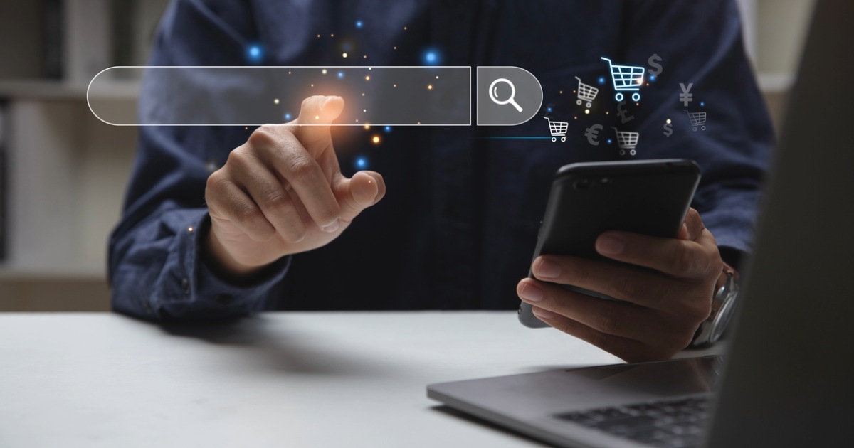 Person using digital devices to search and shop online, symbolizing business success with Sitecore ecommerce integrations