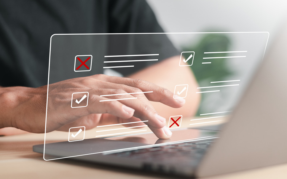 Hands typing on laptop with graphics showing data, illustrating effectiveness of A/B testing in digital marketing efforts