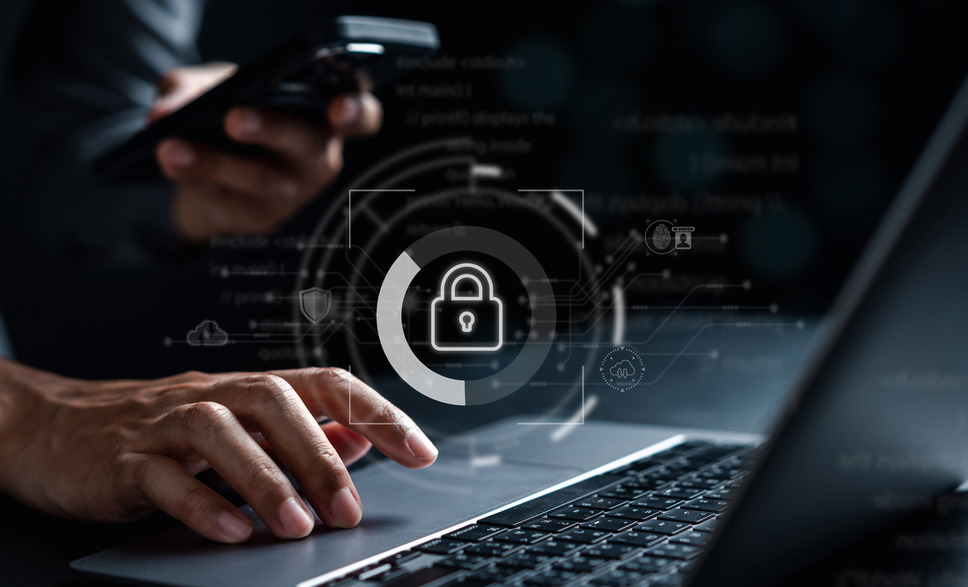 Person using digital devices with a digital padlock overlay, representing digital privacy protection in online environments