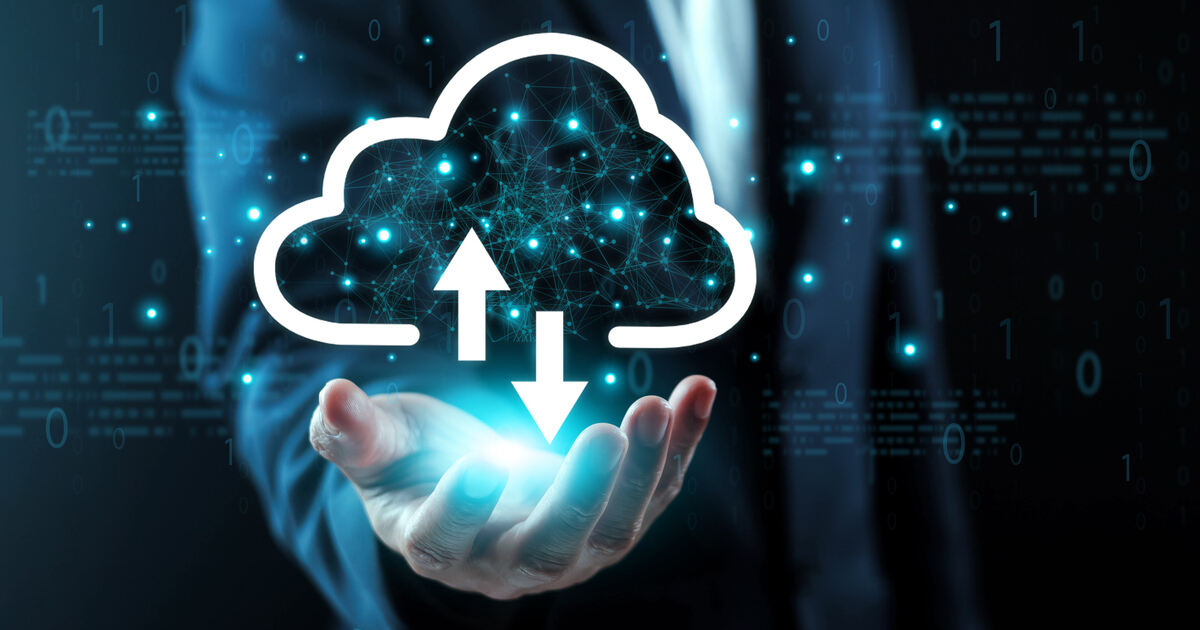 Person holding a glowing cloud upload and download icon, representing cloud management, cloud computing, and data security.