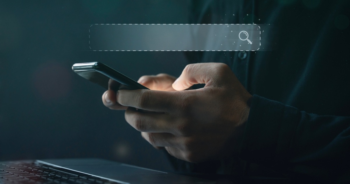 Person using digital devices with digital search bar overlay, symbolizing site search technology and SEO optimization for UX