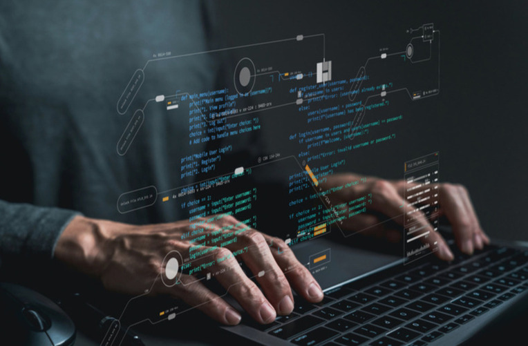 Developer coding on a laptop with programming diagrams, representing success with web development frameworks and processes