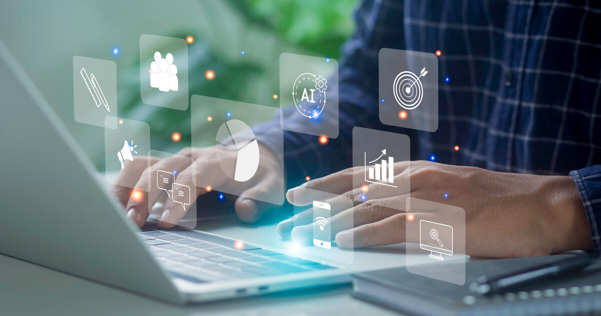 Person with laptop with AI, analytics, and marketing icons overlay, representing data-driven digital strategy and automation.