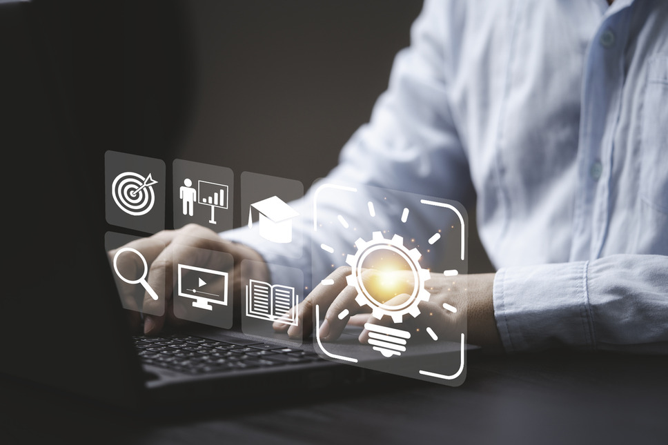 Person on laptop with innovation and digital icons overlayed, symbolizing key takeaways and insights from Sitecore Symposium