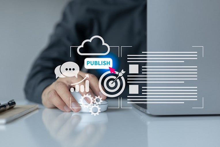 Person using a laptop with virtual content management icons floating above hand, symbolizing digital publishing.