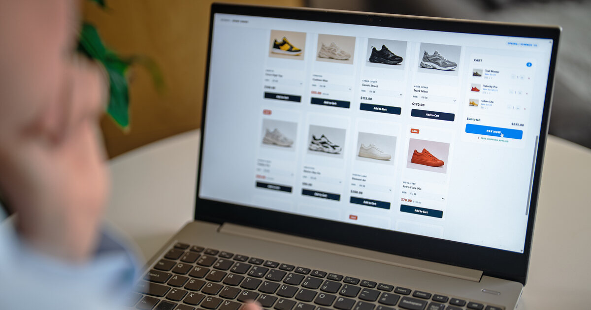 Ecommerce website showing shoe product listings, add-to-cart buttons, and a digital shopping cart on a laptop.