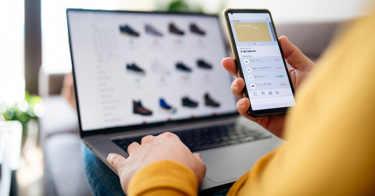 User shopping online with smartphone and laptop, illustrating ecommerce, mobile payments, and omnichannel retail experiences.
