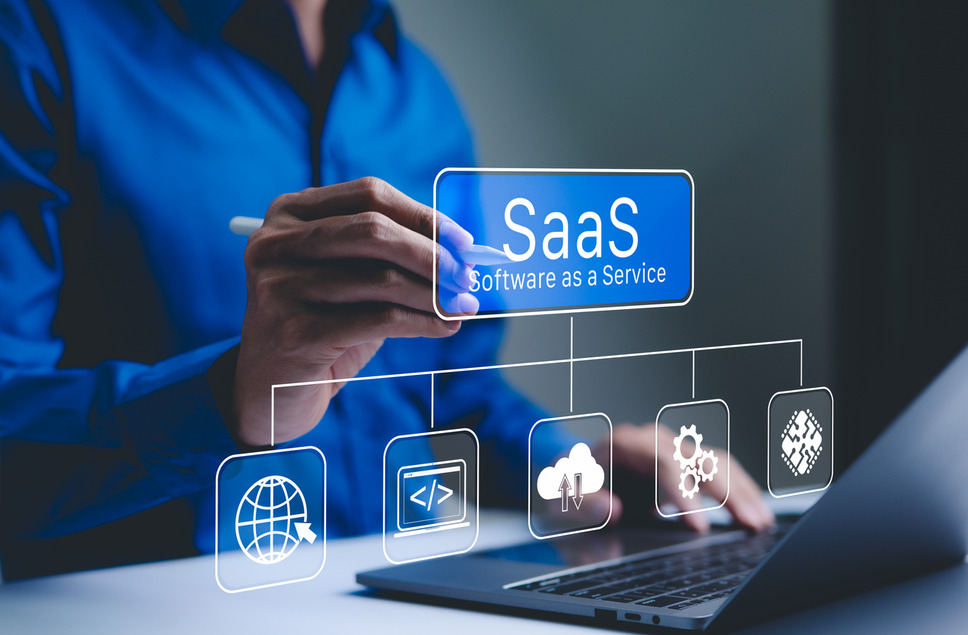 Person interacting with SaaS digital interface using laptop, signifying business success with Software as a Service