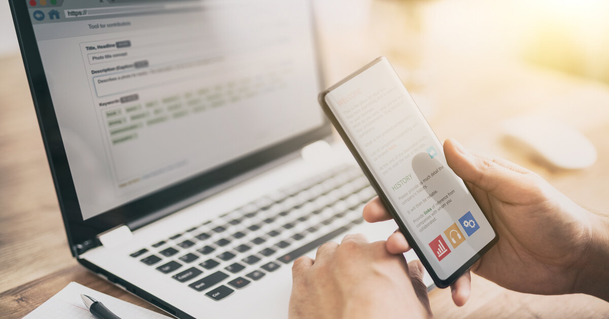Mobile-friendly website displayed on smartphone and laptop, highlighting WordPress web design and user experience.