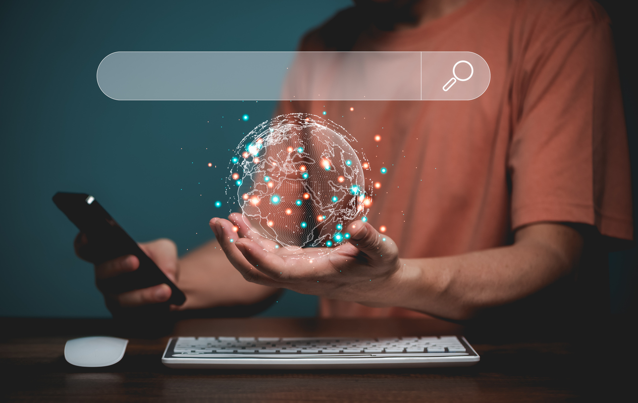 Person with phone and digital globe, symbolizing physical business success achievable with website agency local SEO services