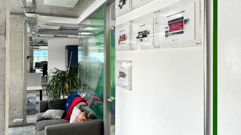 Cozy office lounge area, adjacent to a workspace, representing welcoming work environment at Americaneagle.com Sofia location
