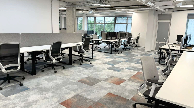 Americaneagle.com' Sofia Bulgaria office interior featuring multiple workstations with ergonomic chairs and large windows