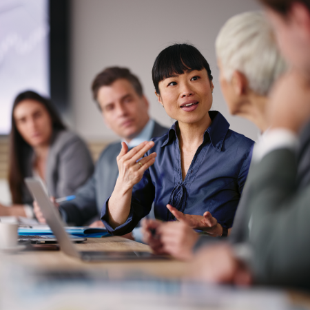 Professionals collaborating during a business meeting, showing digital marketing success for financial services